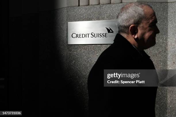 People walk by the New York headquarters of Credit Suisse on March 15, 2023 in New York City. After its largest shareholder said it could not provide...