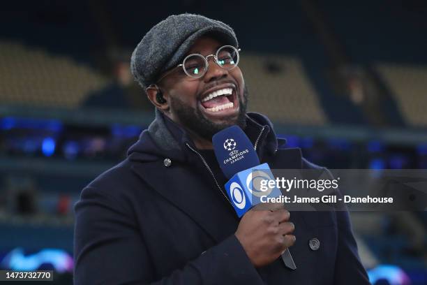 Sports pundit Micah Richards laughs during the UEFA Champions League round of 16 leg two match between Manchester City and RB Leipzig at Etihad...