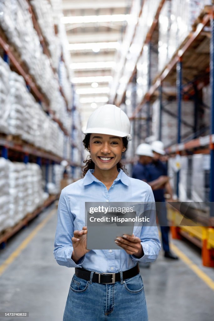Happy woman working at a distribution warehouse