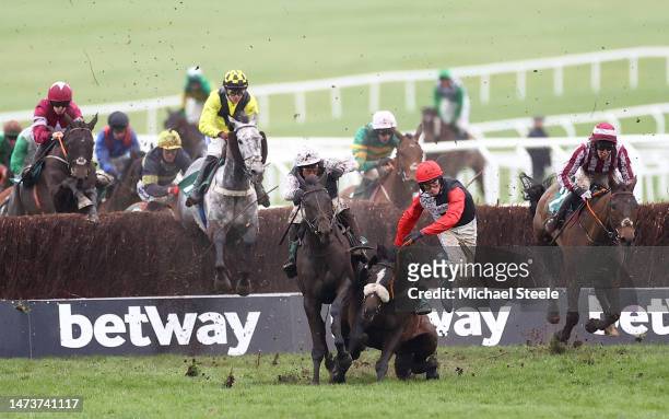 Harry Cobden riding Thyme White is unseated during the Grand Annual Chase during day two of the Cheltenham Festival 2023 at Cheltenham Racecourse on...