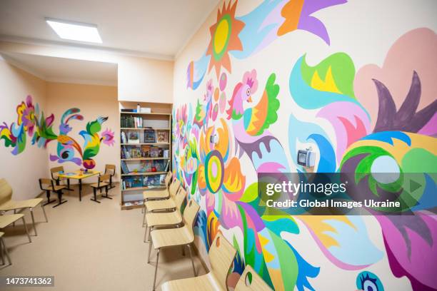 Walls of a children's library basement, used as a bomb shelter, remain painted with Samchykivka ornament on March 15, 2023 in Kyiv, Ukraine. In Kyiv,...