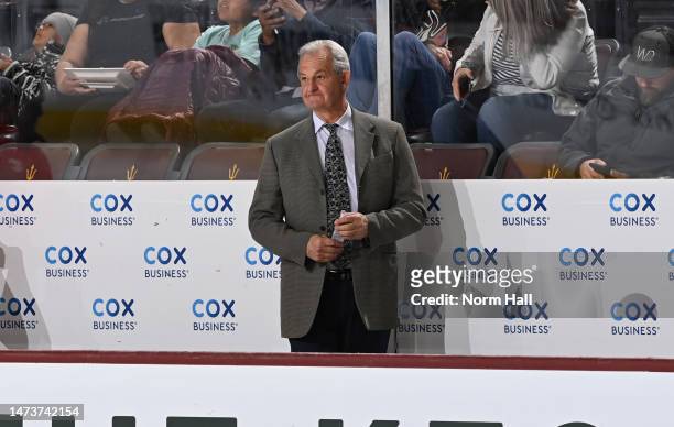 Head coach Darryl Sutter of the Calgary Flames stands on the bench prior to the start of the second period against the Arizona Coyotes at Mullett...