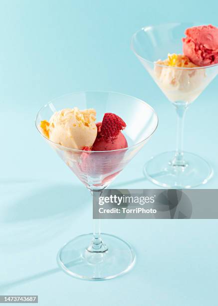 two scoop of fruit sorbet in cocktail glass on blue background - scoop shape photos et images de collection