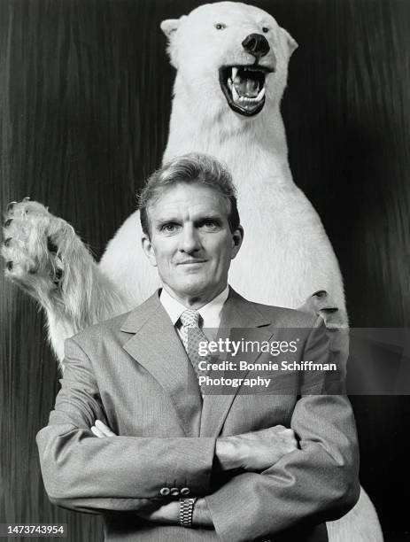 Times owner Otis Chandler poses with arms crossed in front of a taxidermy polar bear in Los Angeles in 1979.