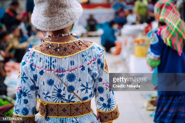 woman of the hmong indigenous tribe visiting the local market in bac ha, vietnam - bac ha stock pictures, royalty-free photos & images