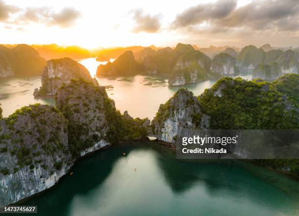 top view over ha long bay in north vietnam during sunset - halong bay stock pictures, royalty-free photos & images