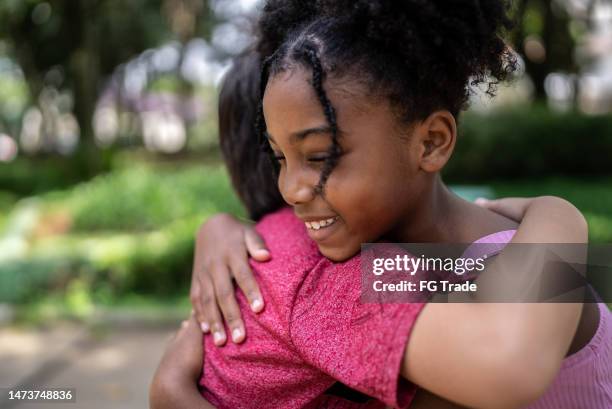 kids embracing in a park - alpha males stock pictures, royalty-free photos & images