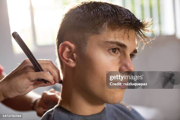 teenager at hair salon - teenage boy shave imagens e fotografias de stock