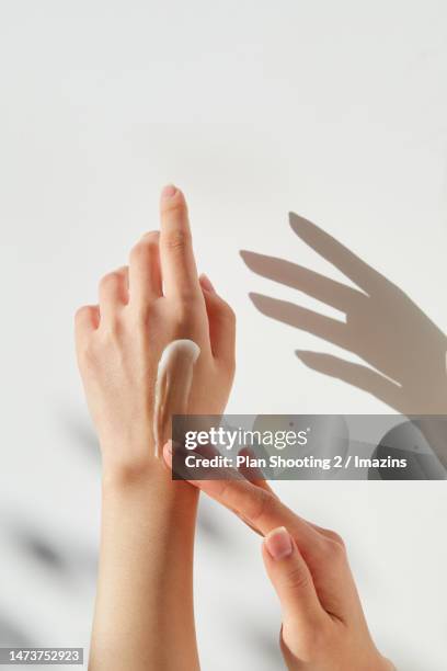 human hand, lotion, smoothness, human skin - hand cream stock pictures, royalty-free photos & images