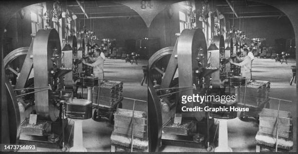 Stereoscopic image showing a row of coin presses attended by two operators at the Philadelphia Mint building on Spring Garden Street in Philadelphia,...
