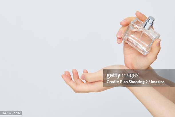 human hand, motion, perfume, sprinkling, wrist - wrist stock pictures, royalty-free photos & images