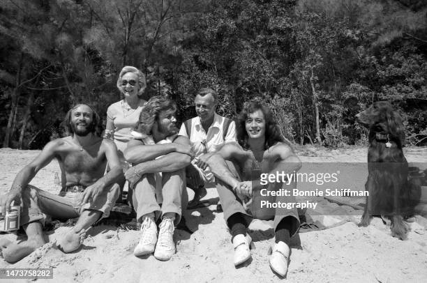 Barry, Maurice and Robin Gibb sit on the beach with their parents in Florida in 1979.
