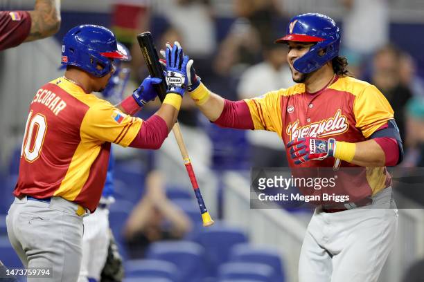 Eugenio Suárez of Team Venezuela celebrates with Eduardo Escobar after hitting a home run against Team Israel during the sixth inning in a World...