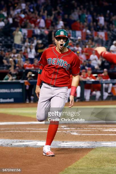 Joey Meneses of Team Mexico reacts after scoring against Team Canada during the first inning of the World Baseball Classic Pool C game at Chase Field...