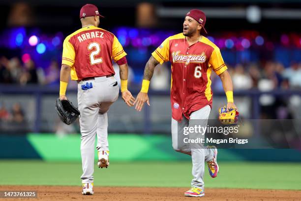 Luis Arraez and David Peralta of Team Venezuela celebrate after defeating Team Israel in a World Baseball Classic Pool D game at loanDepot park on...