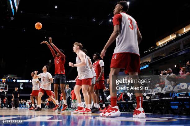 Alabama Crimson Tide players shoot during a practice session ahead of the first round of the NCAA Men’s Basketball Tournament at Legacy Arena at the...