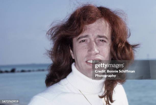 Musician Robin Gibb poses in front of the ocean in Florida in 1979.