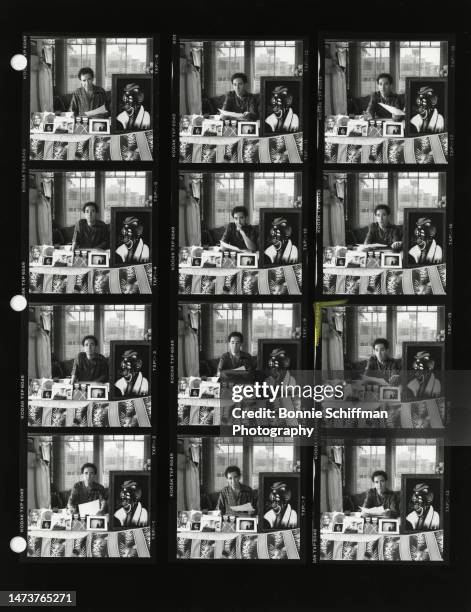 Comedian Harry Shearer sits behind a table with different art displayed on it in Los Angeles in 1990 in these twelve images on a single proof sheet.