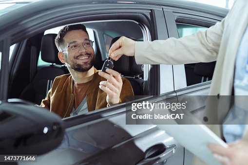 A young man buys a new car A young man buys a new car