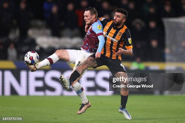 Connor Roberts of Burnley is challenged by Allahyar Sayyadmanesh of Hull City during the Sky Bet Championship between Hull City and Burnley at MKM...