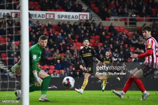 James McAtee of Sheffield United scores the team's first goal as Anthony Patterson of Sunderland looks on during the Sky Bet Championship between...
