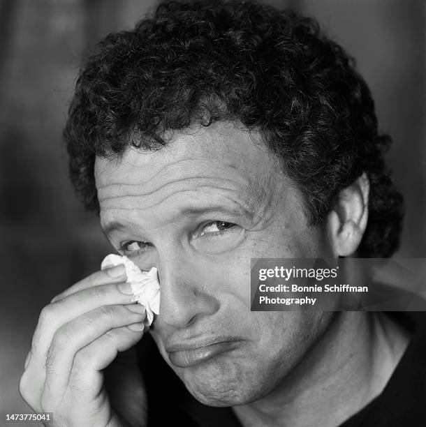Actor Albert Brooks pouts at camera and uses a tissue to dab his undereye in Los Angeles in 1987.