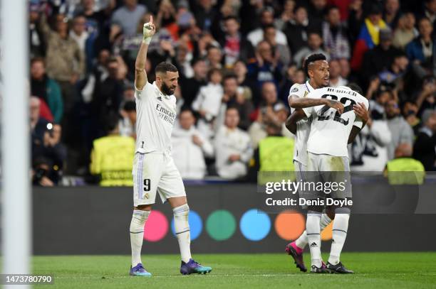 Karim Benzema of Real Madrid celebrates after scoring the team's first goal with teammates during the UEFA Champions League round of 16 leg two match...