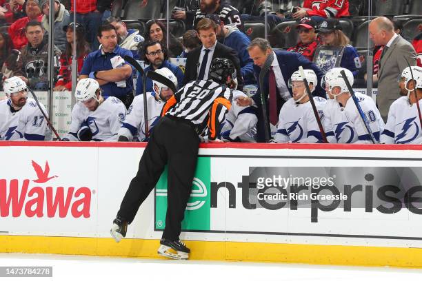 Referee Kevin Pollock talks with John Cooper Tampa Bay Lightning head coach during the game against the New Jersey Devils on March 14, 2023 at the...