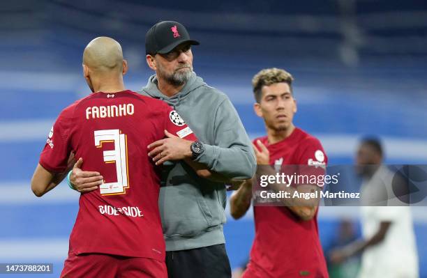 Juergen Klopp, Manager of Liverpool, embraces Fabinho after the UEFA Champions League round of 16 leg two match between Real Madrid and Liverpool FC...