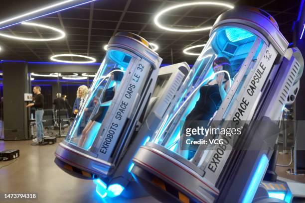 Space capsules' containing humanoid robots are seen at EX Future Science and Technology Museum on March 15, 2023 in Dalian, Liaoning Province of...