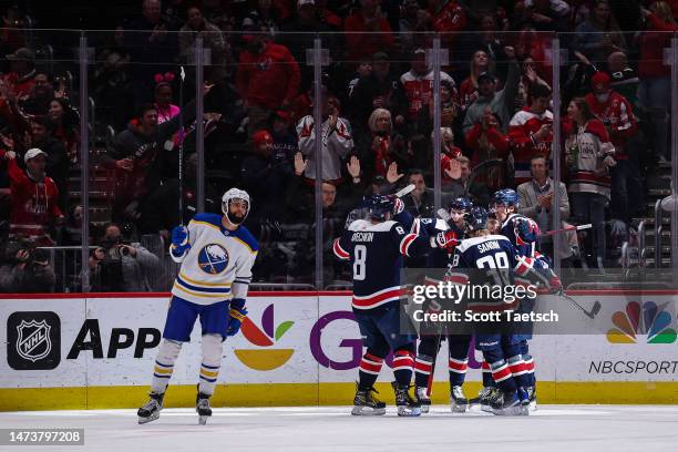 Oshie of the Washington Capitals celebrates with teammates after scoring a goal against the Buffalo Sabres during the first period of the game at...