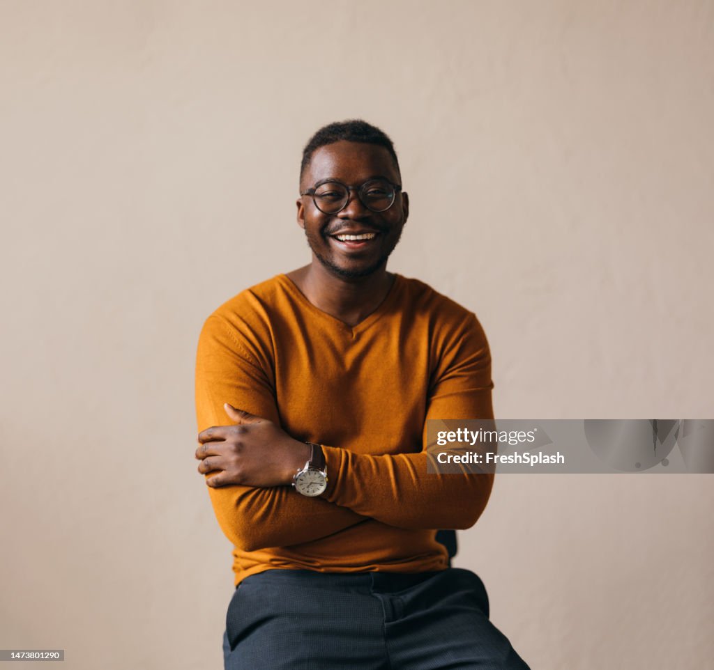A Happy Businessman With Glasses Looking At Camera
