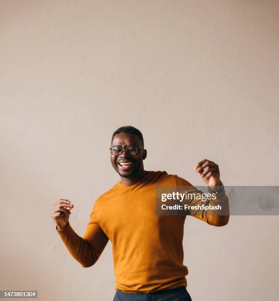 a happy businessman with glasses celebrating some business success - celebrate yourself bildbanksfoton och bilder