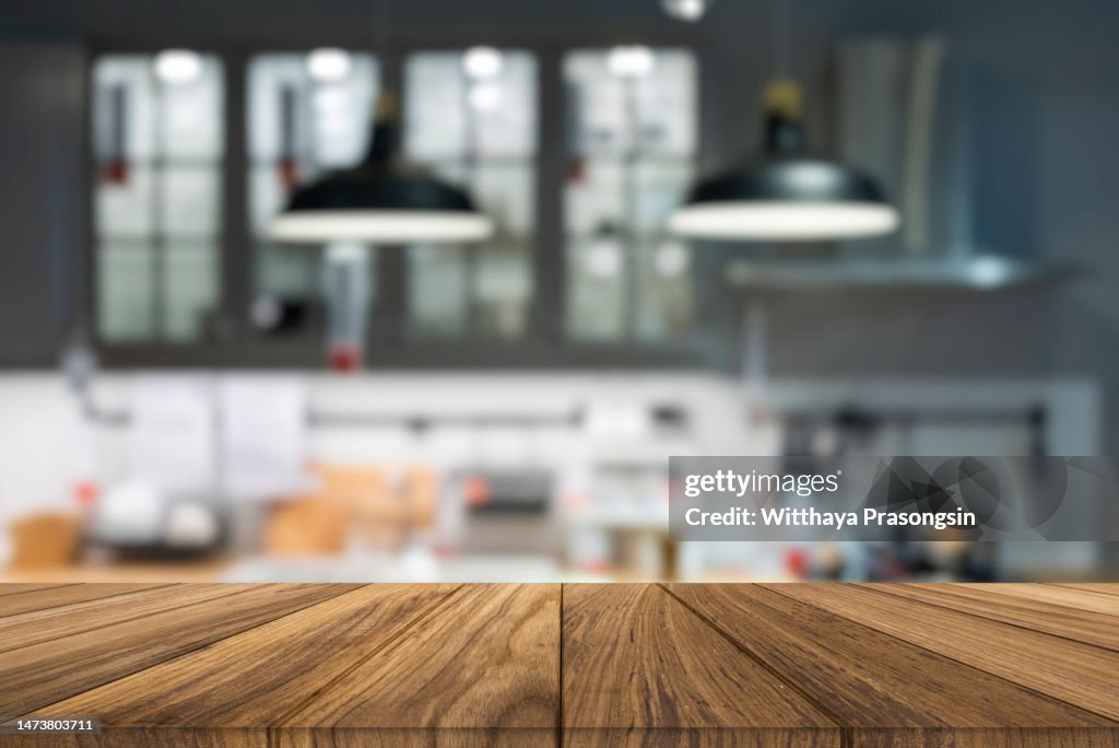 Wooden tabletop over defocused kitchen background