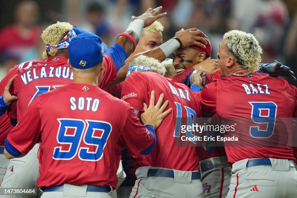 Francisco Lindor of Puerto Rico celebrates with teammates after he scored during the fifth inning of the World Baseball Classic Pool D game against...