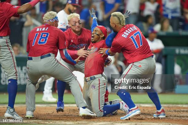 Francisco Lindor of Puerto Rico celebrates with teammates after he scored during the fifth inning of the World Baseball Classic Pool D game against...
