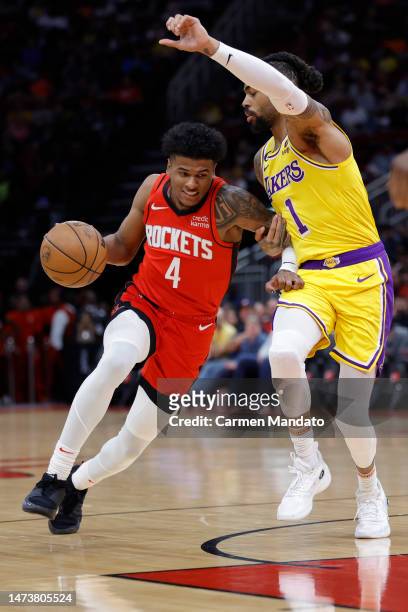Jalen Green of the Houston Rockets controls the ball against D'Angelo Russell of the Los Angeles Lakers during the first half at Toyota Center on...