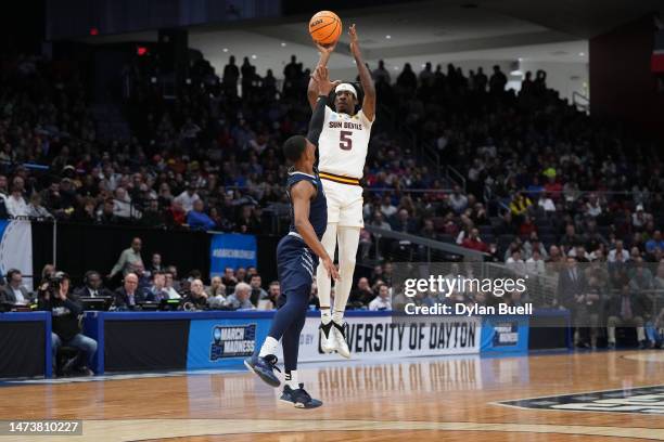 Jamiya Neal of the Arizona State Sun Devils attempts a three point basket over Hunter McIntosh of the Nevada Wolf Pack during the first half in the...