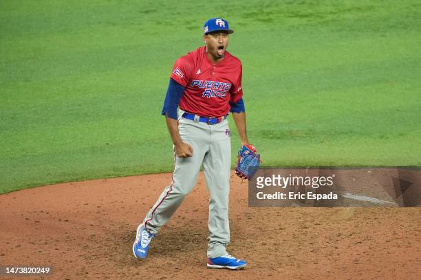 Edwin Diaz of Puerto Rico celebrates after the first out of the ninth inning of the World Baseball Classic Pool D of the game against the Dominican...