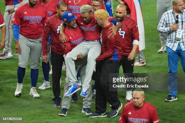 Edwin Diaz of Puerto Rico is helped off the field after being injured during the on-field celebration after defeating the Dominican Republic during...