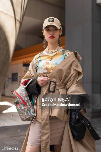 Guest is seen wearing trenchcoat and pearls attending Pillings in Shibuya at Rakuten Fashion Week TOKYO 2023 A/W on March 16, 2023 in Tokyo, Japan.