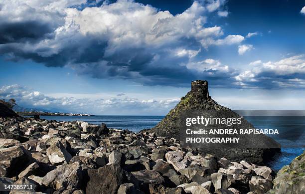 rocky seascape with dramatic clouds - acireale stock pictures, royalty-free photos & images