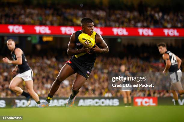 Maurice Rioli of the Tigers runs with the ball during the round one AFL match between Richmond Tigers and Carlton Blues at Melbourne Cricket Ground,...