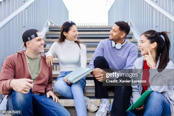 international young exchange group of diverse student friends talking on college campus. - very young asian girls ストックフォトと画像