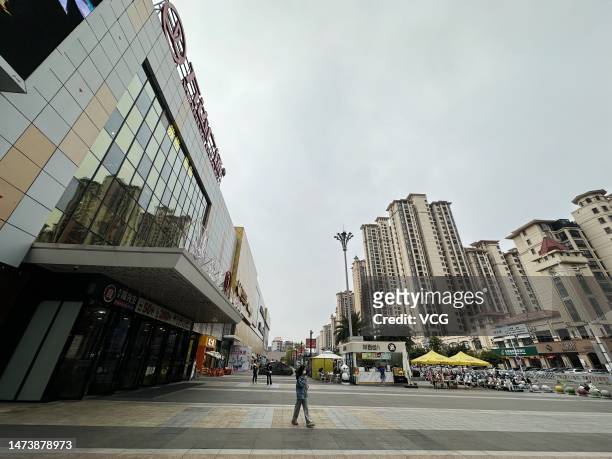 Citizen walks past Wanda Plaza shopping mall on March 15, 2023 in Yulin, Guangxi Zhuang Autonomous Region of China.