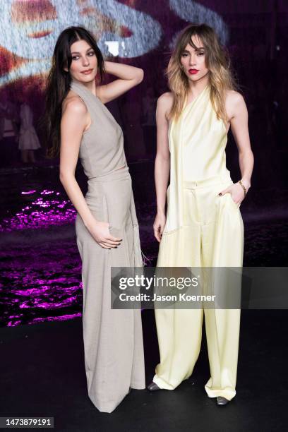 Camila Morrone and Suki Waterhouse attend the Boss Spring/Summer 2023 Miami Runway Show at One Herald Plaza on March 15, 2023 in Miami, Florida.