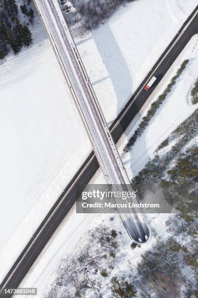 truck on a winter road at a railway bridge - snow directly above stock pictures, royalty-free photos & images