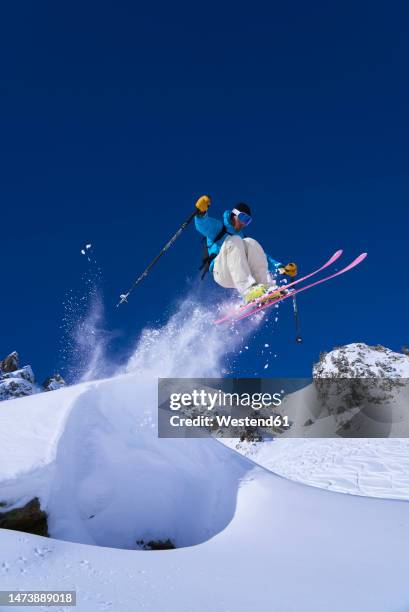 skier jumping off snow on mountain - skier jumping stock pictures, royalty-free photos & images