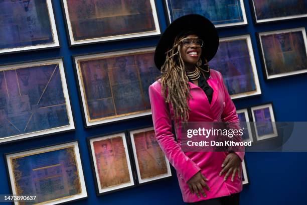 Artist Adelaide Damoah stands besides pieces of her art by during a press preview of 'Rites of Passage' on March 16, 2023 in London, England. The...