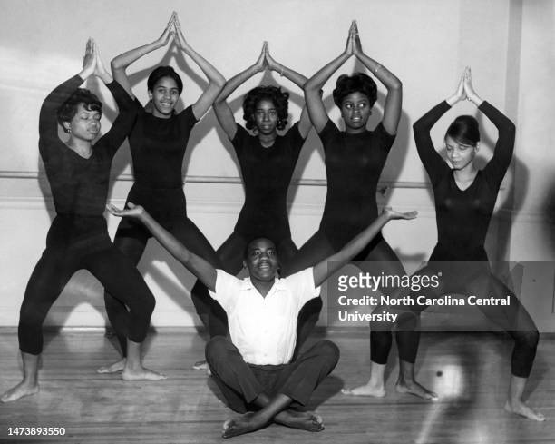 University dance students posing in dance positions for photograph.